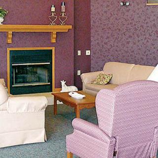 A cozy living room with a fireplace and comfortable seating.