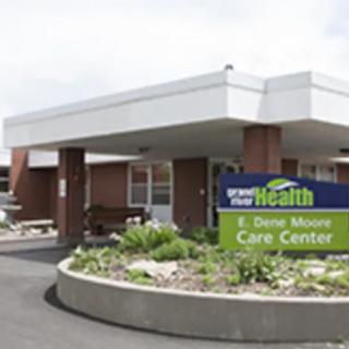 Exterior view of a care center with a sign in front.