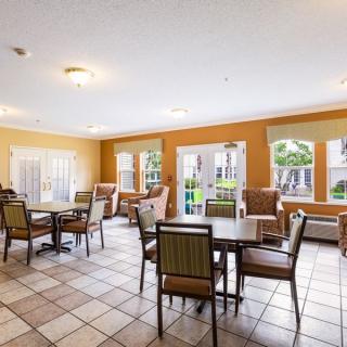 A spacious dining area with tables, chairs, and large windows.