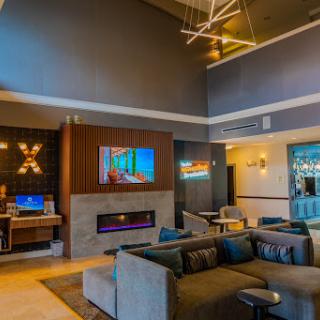 A stylish modern lounge featuring comfortable seating and a contemporary fireplace.