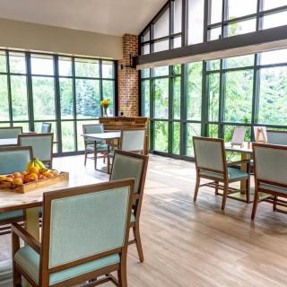 A bright and modern dining area with large windows and elegant furnishings.