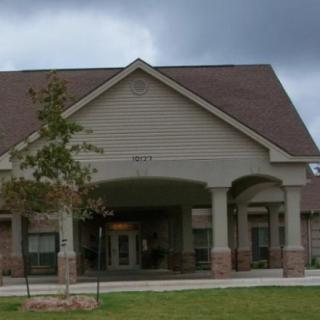 A suburban residential building with a covered entrance.
