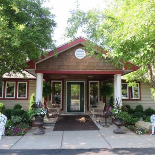 A welcoming building entrance surrounded by greenery and landscaping.