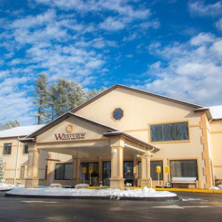 A winter view of a hotel entrance adorned with fresh snow.