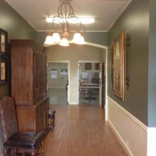 A warmly lit hallway with elegant furniture and decor.
