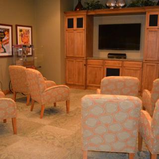 A cozy home theater setup with comfortable seating and a large television.