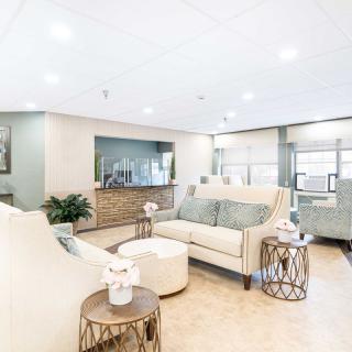 A modern living room with elegant furniture and bright lighting.