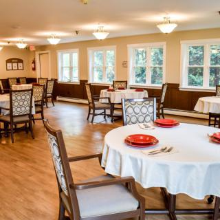 A cozy dining room with elegantly set tables and comfortable seating.