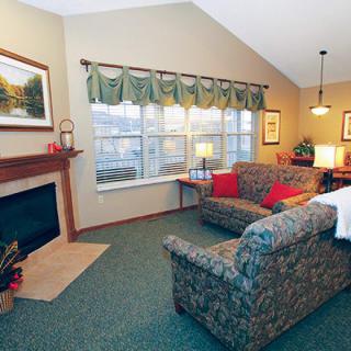 Cozy living room with a fireplace and large windows.