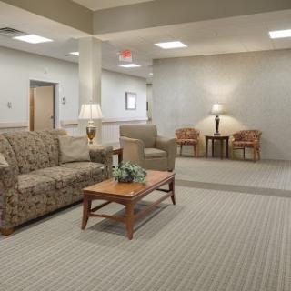 A cozy living room area featuring a sofa, coffee table, and soft lighting.