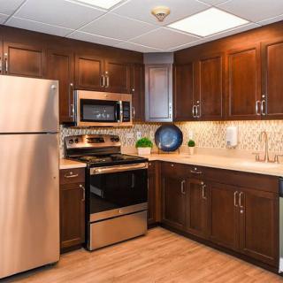 A modern kitchen with stainless steel appliances and wooden cabinets.