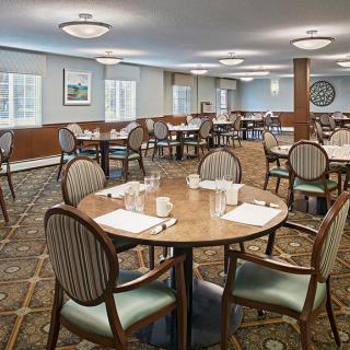 An elegant dining room with neatly arranged tables and chairs.