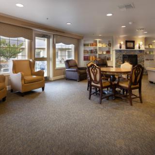 Cozy living room with comfortable seating, a fireplace, and a bookshelf.