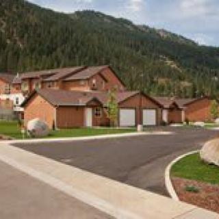 A peaceful residential area nestled in a mountainous landscape.