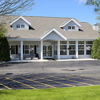 A commercial building with a parking lot in front.