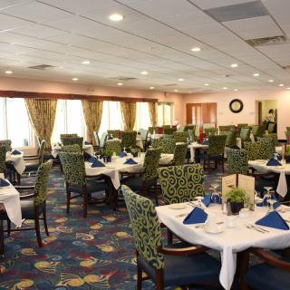 A spacious dining room with neatly arranged tables and chairs.
