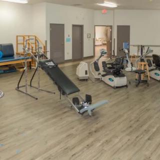 A spacious gym with various exercise equipment for fitness training.