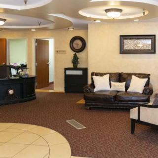 A well-decorated lobby with a comfortable sofa and coffee table, creating an inviting reception area.