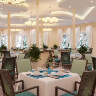 An elegantly designed restaurant interior with neatly arranged tables and chairs, set for dining.