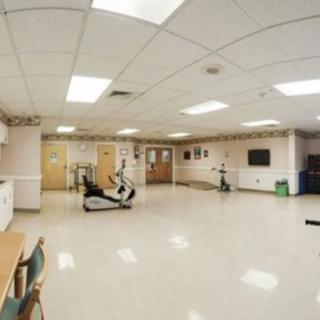 A spacious gym with exercise equipment and a clean interior.