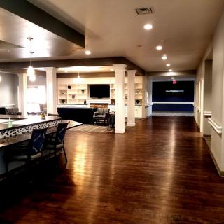 A spacious, modern interior featuring an open-concept living and dining area with hardwood flooring.