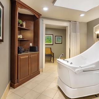 A modern spa interior featuring a luxurious bathtub and elegant decor.