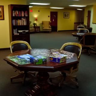 A cozy lounge area with a table set up for puzzles.