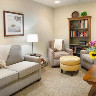 A cozy living room with comfortable seating and a bookshelf filled with books.