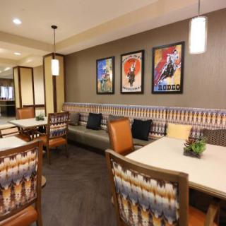 Cozy modern dining area with stylish artwork and seating.