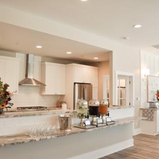 A modern kitchen featuring stainless steel appliances and marble countertops in an open-concept design.