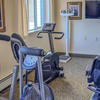 A small home gym with stationary bikes and fitness equipment.
