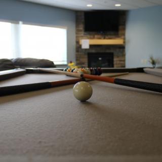 A pool table in a cozy game room setting.