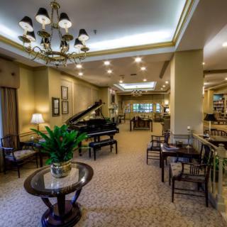 A luxurious lobby with a grand piano and elegant seating arrangements.