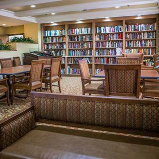 A cozy library interior with bookshelves and seating areas.