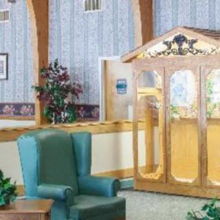 A cozy waiting area with comfortable seating and decorative elements, including a confessional booth.