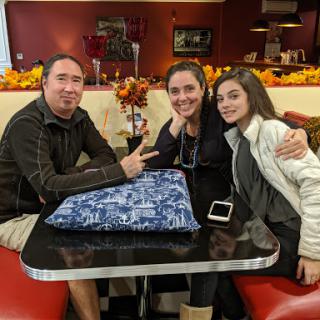 A happy family enjoying a meal together at a cozy restaurant.