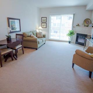 A cozy living room with comfortable seating and a fireplace.