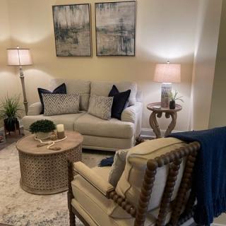 A cozy living room with stylish furniture and warm lighting.