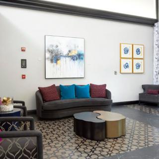 A modern lobby area featuring stylish furniture and contemporary artwork.