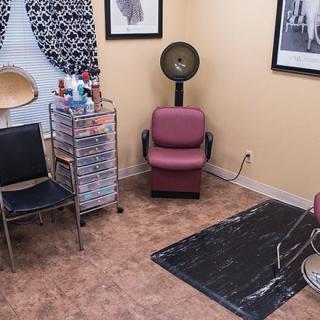 A cozy salon room with hairdressing equipment and stylish decor.