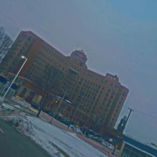 A historic building amidst a snowy landscape in an urban setting.