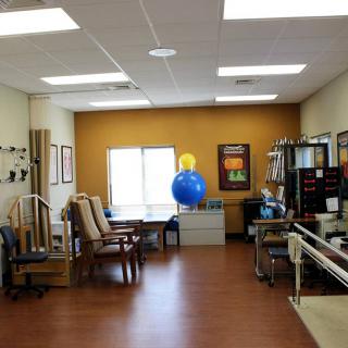 A physical therapy clinic equipped with various exercise tools and a large fitness ball.