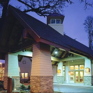 A modern building entrance illuminated during the evening.