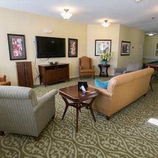 A cozy living room with comfortable seating and a large television.