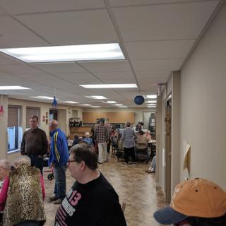 A busy indoor space filled with people engaged in various activities.
