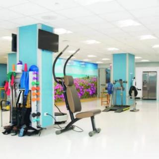 A modern gym with various exercise equipment in a clean and bright setting.