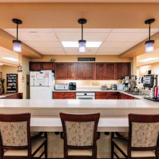 A cozy kitchen with a spacious countertop and bar seating.