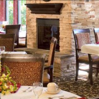 Elegant dining room interior with a cozy fireplace.