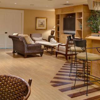 A cozy living room with comfortable seating, wooden flooring, and a built-in television.