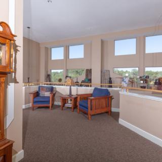 A spacious and well-lit lobby area with comfortable seating and large windows.